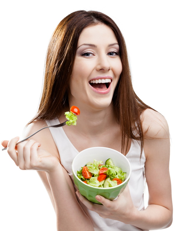 Dieting woman eats green salad in salad bowl, isolated on white